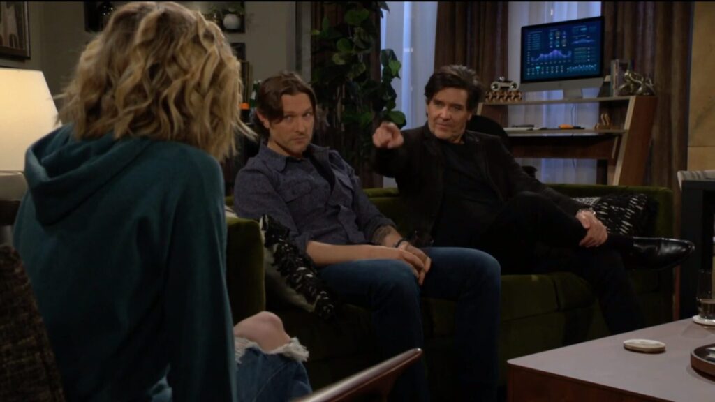 Danny points at Lucy as they talk.