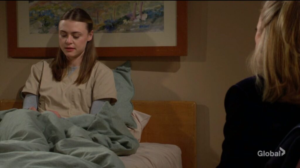 Claire sits in bed as she talks to Nikki.