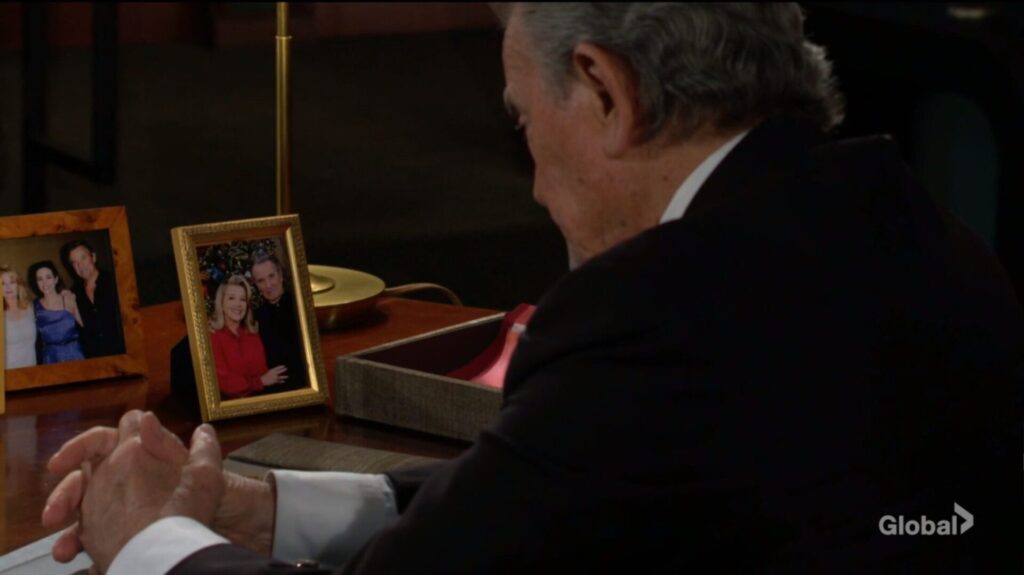Victor looks at a picture of him and his wife.