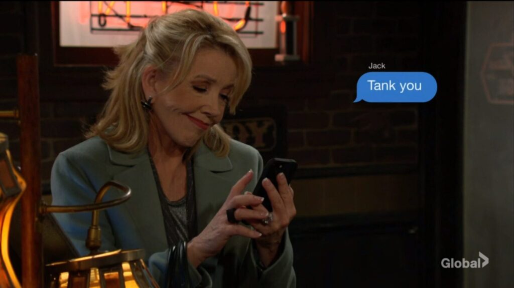 Nikki Newman smiles as she sends Jack a text message. "Tank you."