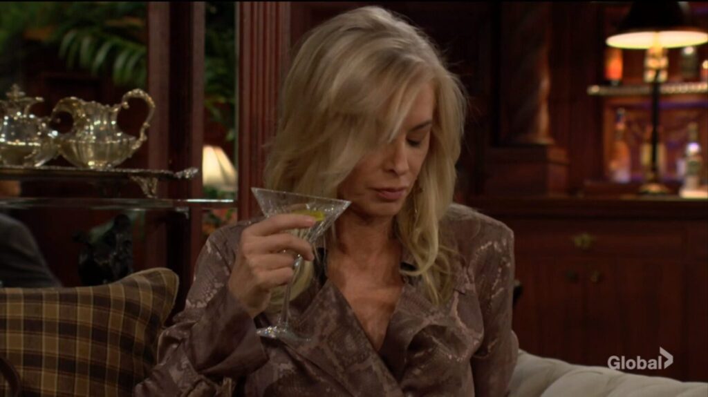 Ashley Abbott holds a martini.