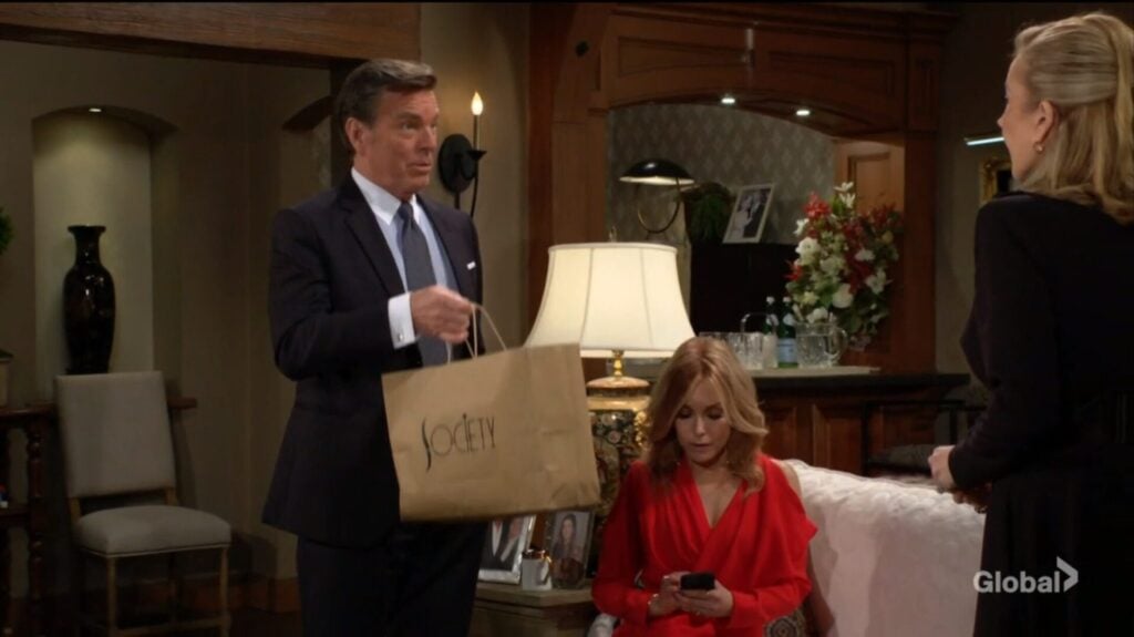 Jack holds up a takeout bag as he talks to Lauren and Nikki.