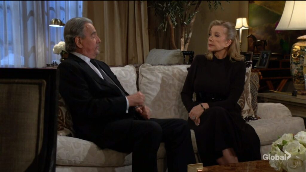 Victor Newman and Nikki Newman sit on the sofa.