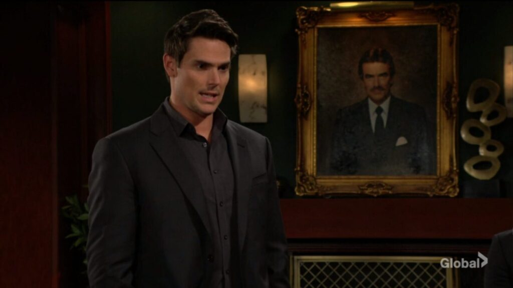Adam Newman in front of his father's portrait.