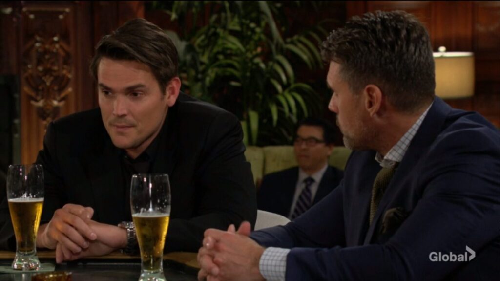 Adam and Nick talk over drinks.
