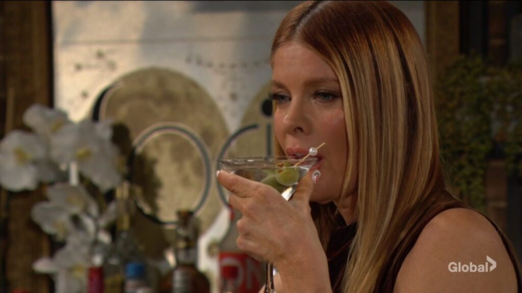 Phyllis drinks her martini.