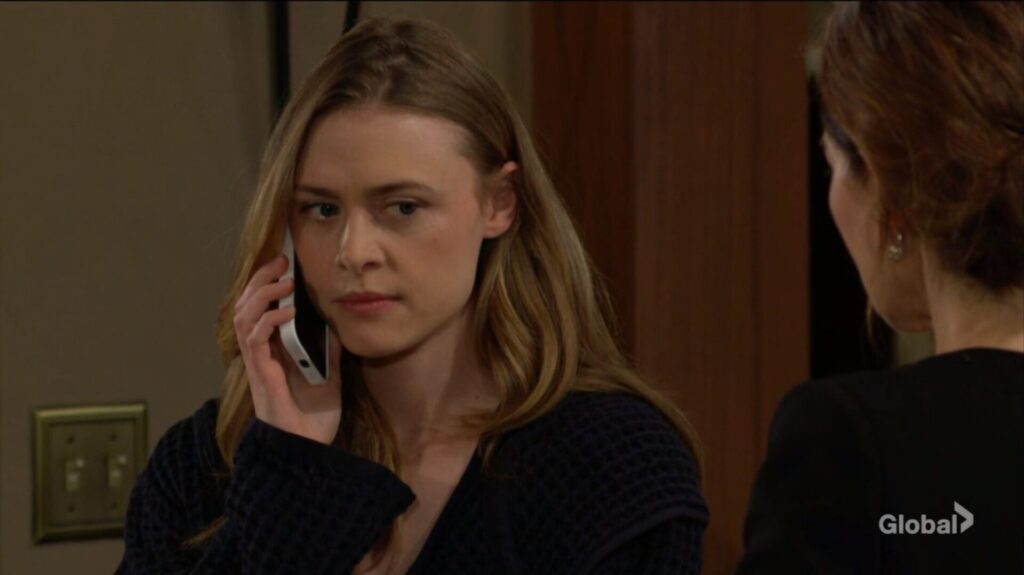 Claire talks on the phone while Victoria Newman listens.