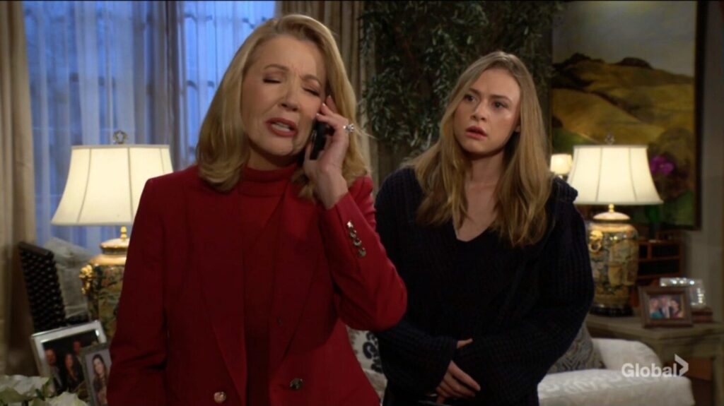Nikki Newman talks on the phone as Claire Grace looks on.