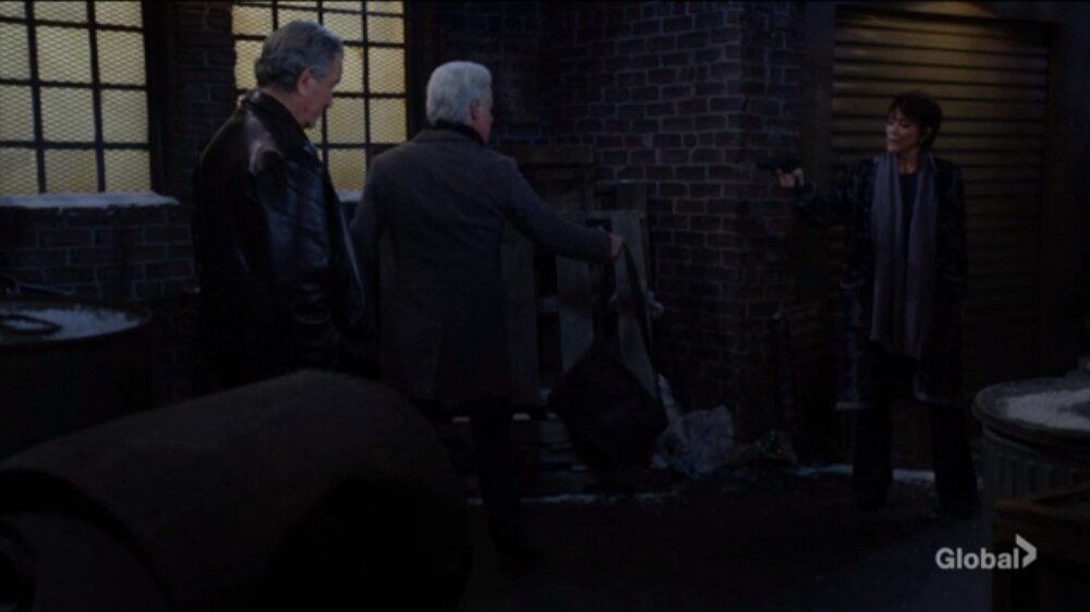 Victor and Jordan watch as Michael drops a duffel bag.