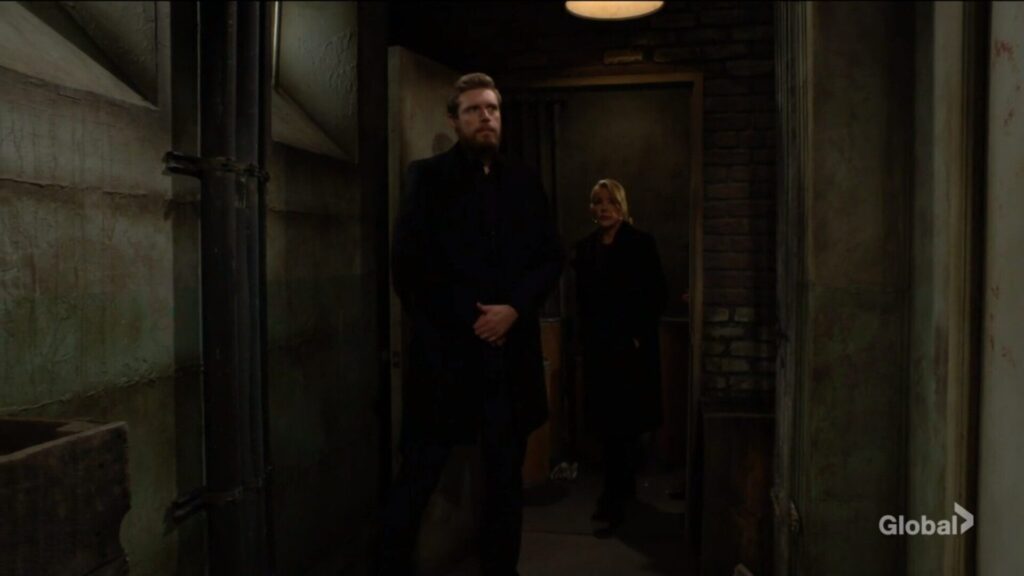 Larry the bodyguard and Nikki Newman enter the basement.