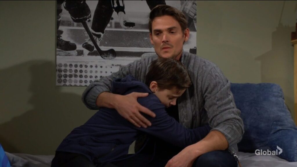 Adam and Connor hug.