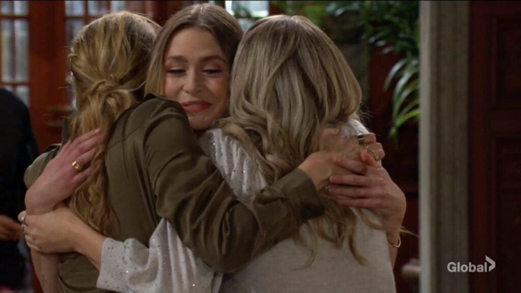 Summer, Claire, and Abby have a group hug.