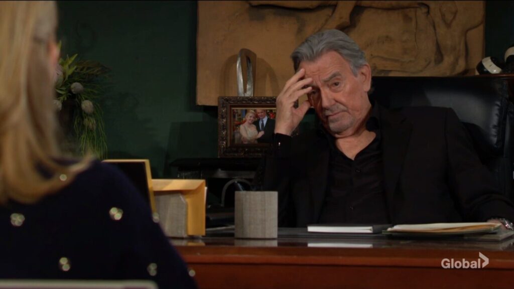 Victor Newman holds his head.