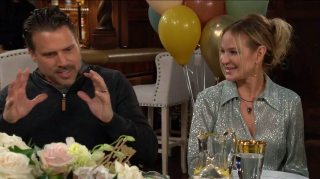Nick Newman gestures as Sharon Newman looks on, laughing.