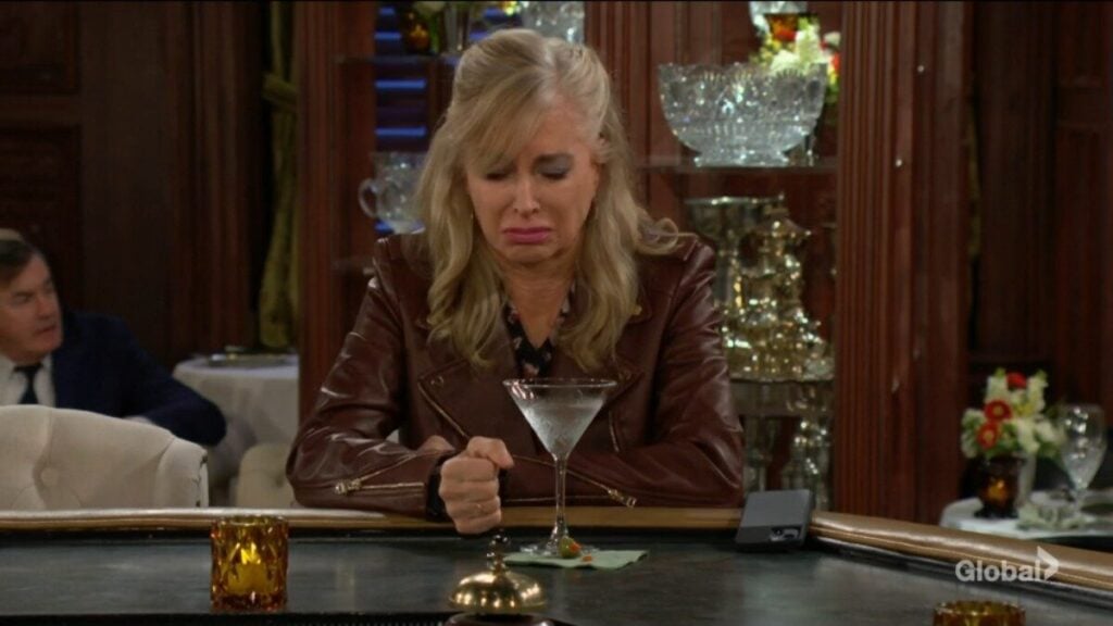 Ashley makes a face as she tastes the martini.