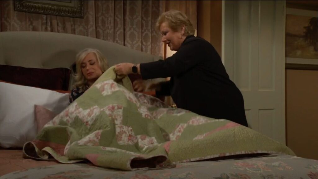 Traci puts a quilt over Ashley.