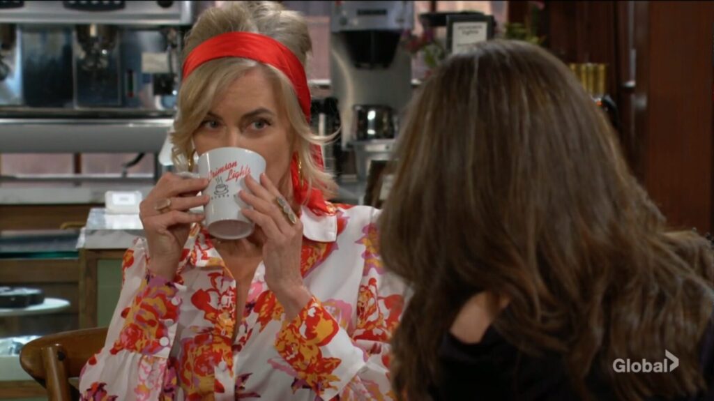 Ashley takes a drink of her coffee.
