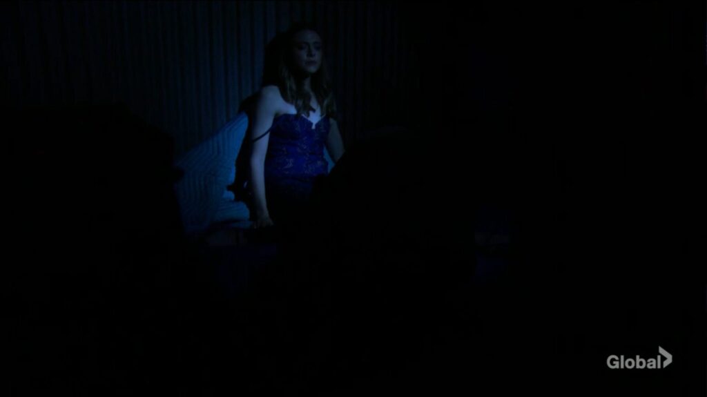 Claire is illuminated by Victoria's flashlight.