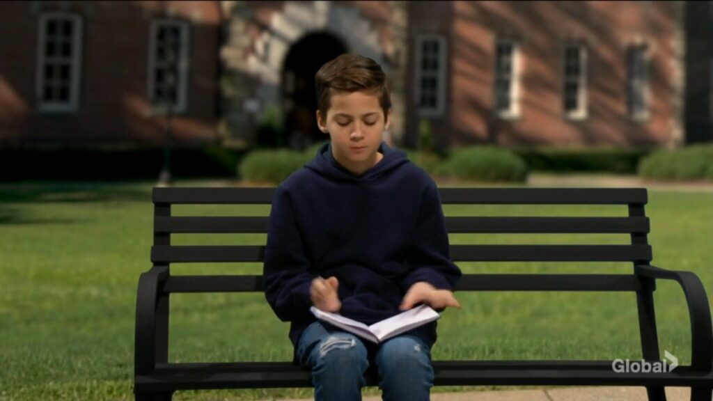 Connor Newman sits on a bench.
