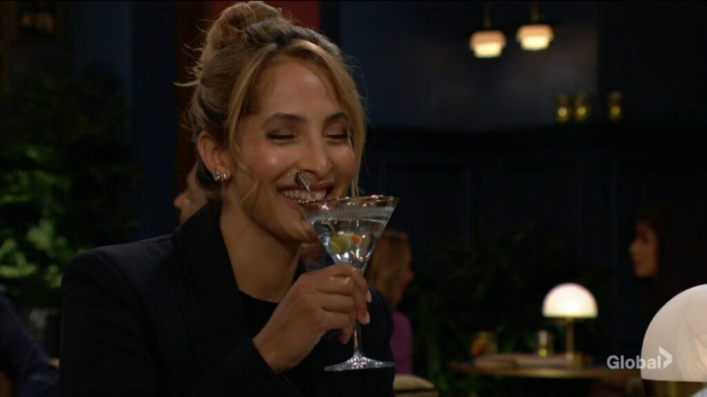 Lily laughs and sips her martini.