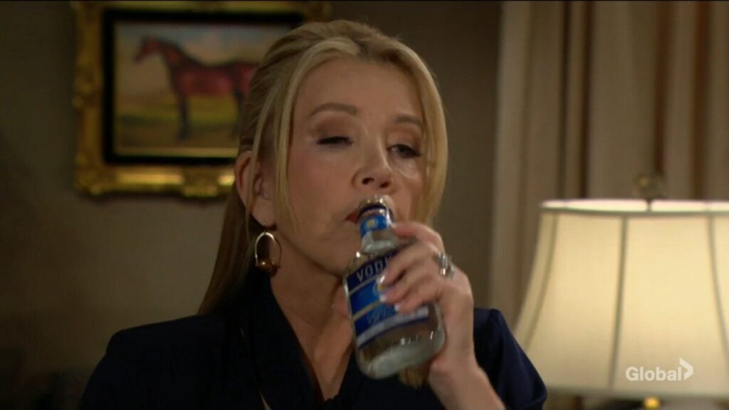 Nikki drinks from a bottle of vodka.