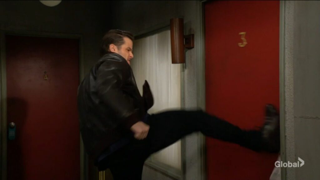Kyle kicks open the motel door.