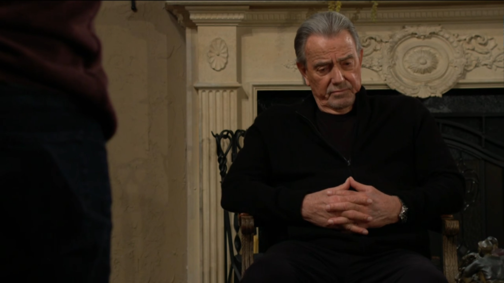 Victor Newman sits with his hands folded.