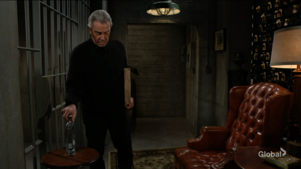 Victor puts a bottle of vodka beside the cell.